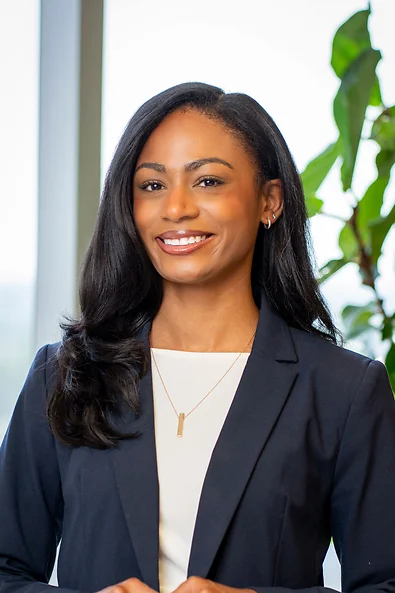 Attorney Taylor Avery smiling wearing a blue blazer jacket and a white shirt